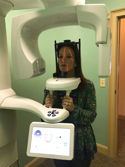 patient having a scan with a CBCT imagery machine for TMJ and Neuromuscular Dentistry diagnosis