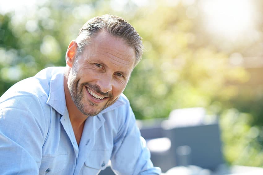mature adult man smiling with teeth