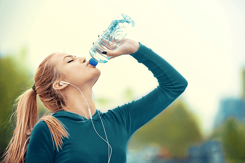 Young woman drinking water while exercising. Dehydration affects more than your mouth. It can also impact your skin, eyes, energy levels, and even weight. So an easy way to improve your lifestyle and your smile is by drinking more water. 