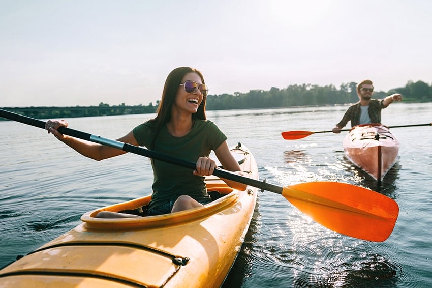 A young couple on the river with a boat. If you’re hoping to feel more confident and happy, there’s an easy solution with cosmetic dentistry.