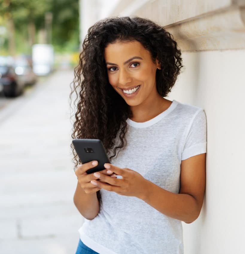 beautiful woman checking her phone and smiling