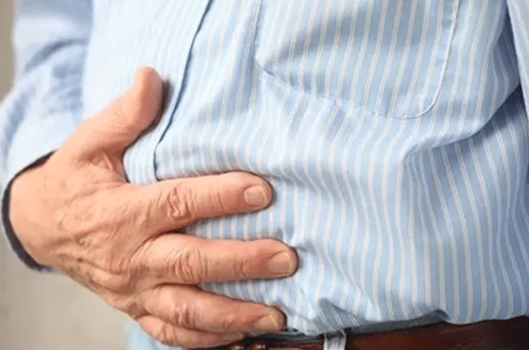 man holding his stomach due to pain